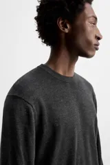 Jersey negro de lana y cashmere, de corte regular, cuello redondo y manga larga.