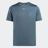 Remera deportiva Reebok de manga corta y cuello redondo, color azul grisáceo, con logo Reebok en blanco en el pecho.