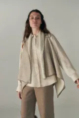 Chaleco marrón con diseño a cuadros, solapas anchas y bolsillos laterales.