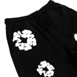 Pantalón de jogging negro con estampado de coronas de algodón blancas.