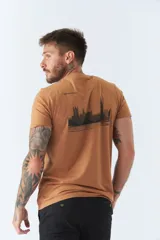 Remera color caramelo de corte clásico, con cuello redondo y manga corta. Estampa pequeña en el pecho con el dibujo de un edificio y la inscripción "BROOKSFIELD".