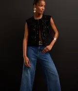 Pantalón de jean de corte wide leg, tiro alto y cintura sastre.