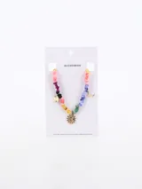 Collar corto con cuentas de piedra de colores y dijes dorados de sol y luna.