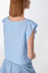 Blusa marrón de lino, de corte holgado y sin mangas.
