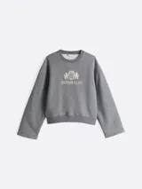 Buzo gris de Tommy Hilfiger de felpa con mezcla de algodón, cuello redondo, hombros caídos y manga ancha. Tiene cuello y bajo de punto canalé, logo bordado en el pecho y logo bordado en el ribete de la manga.