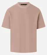 Remera color beige de corte boxy, con escote redondo y mangas cortas. Confeccionada en tejido acanalado de algodón y poliéster.