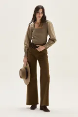 Top negro de calce al cuerpo con escote cuadrado amplio. Mangas largas abullonadas con puños elastizados.