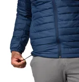 Campera Columbia con capucha, color verde oliva en la parte superior y gris claro en la parte inferior. Cuenta con cierre frontal, bolsillos laterales con cierre y logo de la marca en el pecho.