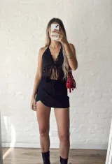 Top negro con escote halter y detalle de encaje en el frente, con tiras regulables.