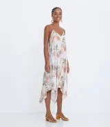 Vestido midi de viscosa con estampado floral en tonos pastel. Presenta escote en V, tirantes delgados ajustables y bajo asimétrico con puntas.