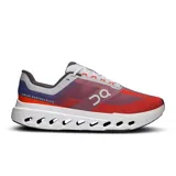 Championes de running On Cloudsurfer Next, color rojo y azul, con detalles en gris y blanco. Presentan tecnología CloudTec Phase para una amortiguación suave y reactiva.