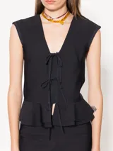 Top blanco de lycra doble, con mangas japonesas y escote en V con lazos de poplin. Tiene doble volado caracol en el ruedo.