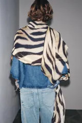 Pañuelo rectangular de modal con estampado de cebra en tonos beige y negro, y terminaciones desflecadas.