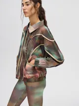 Campera rompevientos estilo biker con capucha desmontable, color celeste con estampado de nubes blancas y detalles en blanco.