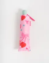 Paraguas corto plegable color rosa con estampado de cerezas, moños y estrellas.