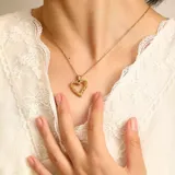 Collar dorado con dije de corazón calado con textura.