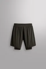 Shorts de running color verde oscuro, confeccionados en tejido técnico ligero y elástico, con malla interior, cintura elástica ajustable con cordón, bolsillos traseros con cierre, perforaciones en las perneras y aberturas laterales.