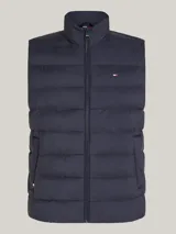 Chaleco acolchado Tommy Hilfiger color azul marino, con cuello alto, cierre de cremallera y dos bolsillos laterales.