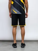 Short deportivo negro con ribete amarillo en el ruedo.