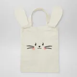 Mini tote bag color beige con estampado de cara de conejo y orejas aplicadas.