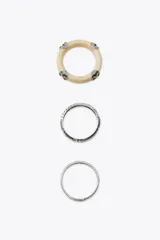 Pack de tres pulseras rígidas para mujer. Incluye una pulsera de resina color crema con apliques metálicos, una pulsera metálica labrada de mayor tamaño y una pulsera metálica labrada más fina.