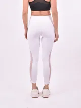 Calza deportiva larga color blanco, de tiro alto y corte ajustado.