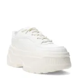 Championes Puma Karmen x, color marfil con detalles dorados y plataforma alta.