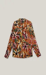 Camisa de manga larga con estampado floral multicolor sobre fondo marrón.