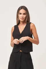 Chaleco sastrero negro con cuello en V y cierre frontal con botones.