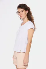 Remera color beige con escote redondo, manga corta, bolsillo en el pecho y cierre parcial con botones.