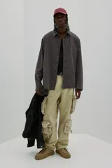 Camisa de franela suave a cuadros grises y marrones, de corte holgado, con cuello inglés, tapeta clásica, canesú en la espalda, bolsillo superior abierto, mangas largas con tapeta de manga y puños abotonados, y bajo levemente redondeado.