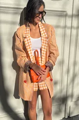 Short de lino a cuadros color naranja y blanco, estilo sastrero con calce holgado.