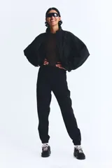 Pantalón de correr negro de tejido funcional DryMove™, corte estándar, cintura elástica con cordón, bolsillos laterales con cierre oculto, piernas levemente ajustadas con elástico revestido y cierre en los bajos. Stretch en cuatro direcciones.