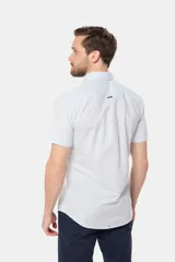 Camisa de hombre color azul marino, de manga corta, con cuello clásico, cierre frontal con botones y bolsillo en el pecho.