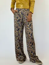 Pantalón de seda estampado en tonos verde oliva y beige, de corte recto y tiro alto, con bolsillos laterales.