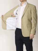Saco sport color beige, con dos botones frontales, solapas de muesca, bolsillo de parche en el pecho y bolsillos de parche en la cadera. Tejido 100% algodón y forro completo interno.
