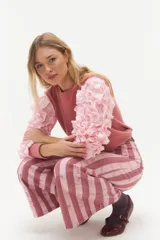 Remera negra de punto con mangas largas abullonadas con volantes.