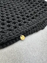 Gorro negro tejido a crochet con diseño calado.