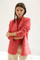 Blazer azul de lino con solapas de muesca, cierre frontal con botón y bolsillos con solapa.