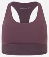 Top deportivo color ciruela con espalda nadadora, copas desmontables y banda elástica en la cintura. Confeccionado en microfibra de poliamida biodegradable.