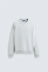 Sweater celeste de algodón con cuello redondo y mangas largas. Tejido con efecto lavado y terminaciones en rib.