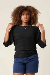 Blusa color rosa claro de hilo con textura acanalada horizontal, escote bote y mangas 3/4. Corte holgado.