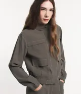 Campera bomber negra de viscosa con cierre delantero, bolsillos con solapa y pespuntes contrastantes en color blanco.