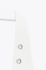 Camiseta blanca de rib con efecto lavado, cuello halter y escote redondo. Detalle de arandelas metálicas en el escote.