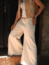 Pantalón de jean color natural, de corte ancho con costuras a la vista y terminación desflecada.