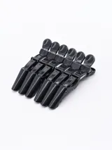Pack de seis pinzas negras para el pelo, con agarre antideslizante y resorte metálico.