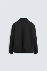 Sobrecamisa negra de algodón con cuello solapa, manga larga con puños abotonados, bolsillos de parche en el pecho y cierre frontal con botones. Corte relaxed fit.