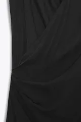 Vestido midi negro de tejido fluido, con cuello halter y escote drapeado en delantero y espalda.