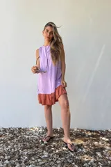 Vestido corto lila con panel frontal en color lavanda y ruedo color ladrillo.