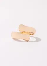 Set de dos anillos dorados de acero quirúrgico hipoalergénico. Uno es un anillo ancho con forma irregular y el otro es un anillo con forma de gota.